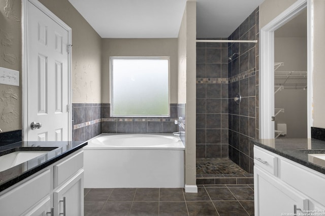 bathroom featuring separate shower and tub, tile flooring, and vanity