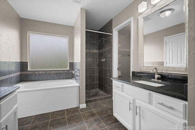 bathroom with shower with separate bathtub, vanity, and tile flooring