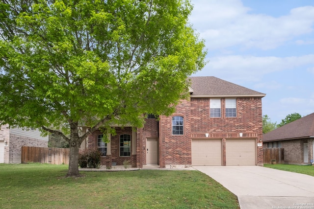 view of front of property with a front yard and a garage