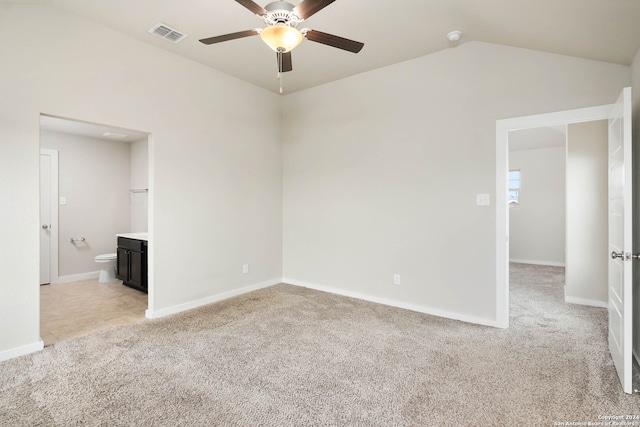 carpeted empty room with ceiling fan and lofted ceiling