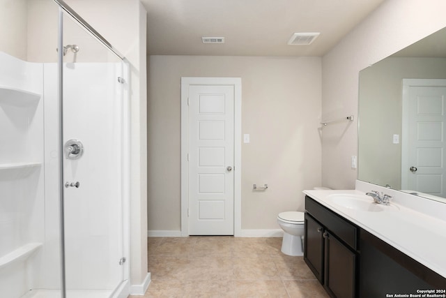 bathroom with walk in shower, tile flooring, vanity with extensive cabinet space, and toilet