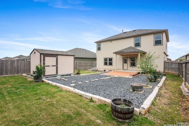 rear view of property featuring a storage unit and a lawn