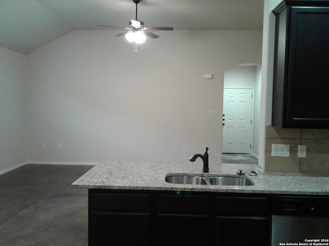 kitchen featuring ceiling fan, lofted ceiling, dishwasher, sink, and light stone countertops