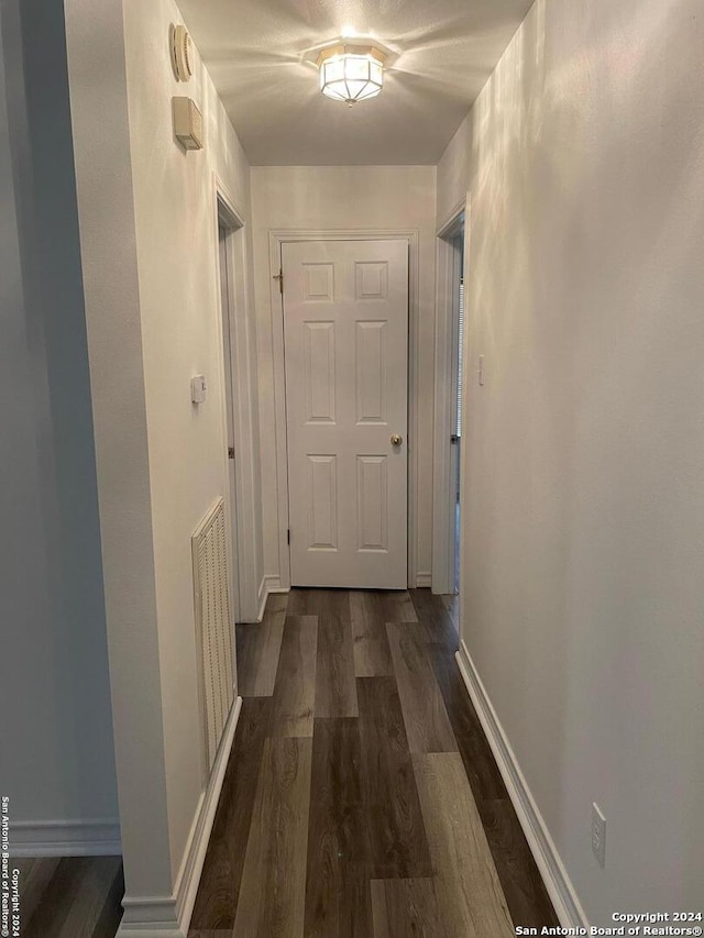 corridor featuring dark wood-type flooring