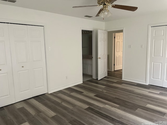 unfurnished bedroom featuring ceiling fan and dark hardwood / wood-style flooring