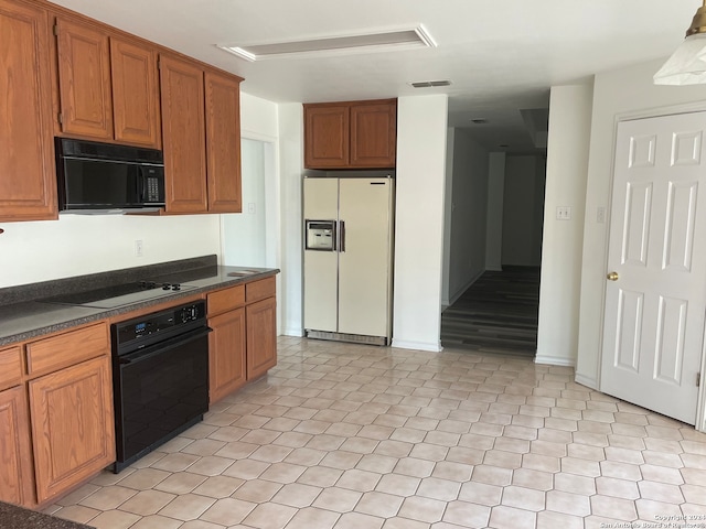 kitchen with light tile floors and black appliances