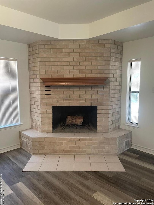 interior details featuring dark hardwood / wood-style floors and a fireplace