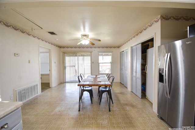 dining space with light tile floors and ceiling fan