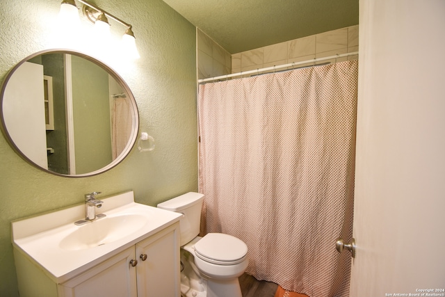 bathroom with toilet, vanity, and wood-type flooring