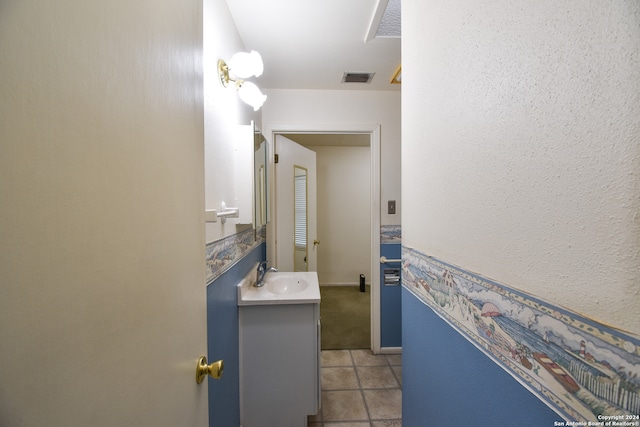 bathroom featuring tile flooring and vanity