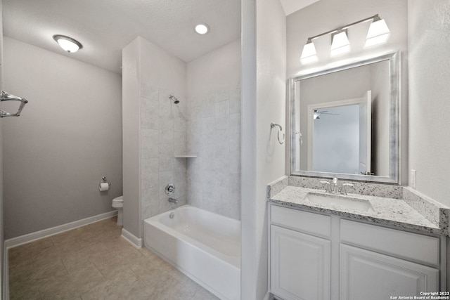 full bathroom with ceiling fan, tiled shower / bath, tile flooring, toilet, and large vanity