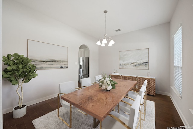 dining area with a notable chandelier and dark hardwood / wood-style floors