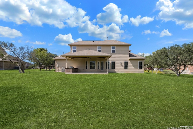 back of house featuring a yard and a patio area