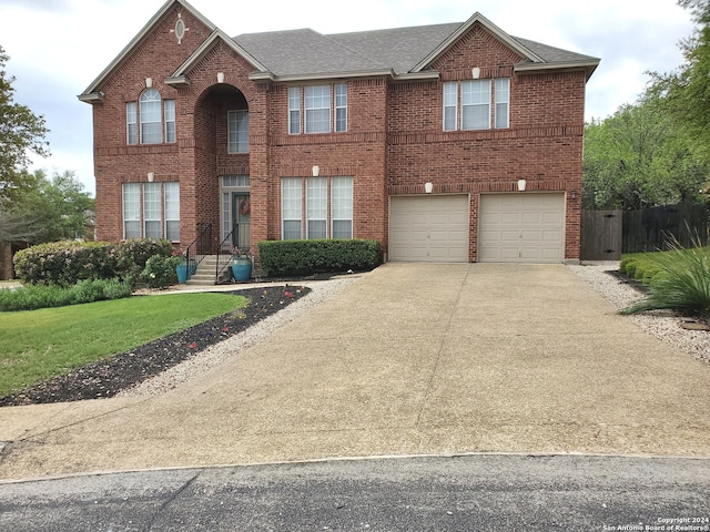 view of front of house with driveway, an attached garage, roof with shingles, and brick siding