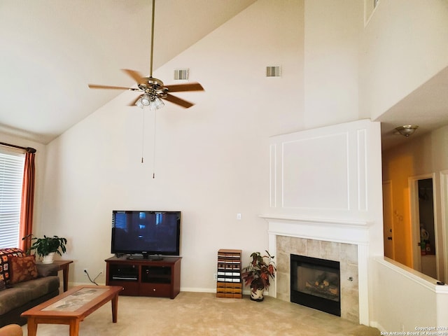 living area with a fireplace, visible vents, light carpet, ceiling fan, and high vaulted ceiling