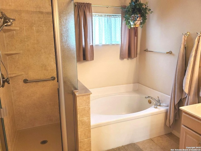 full bath with a stall shower, tile patterned floors, a bath, and vanity