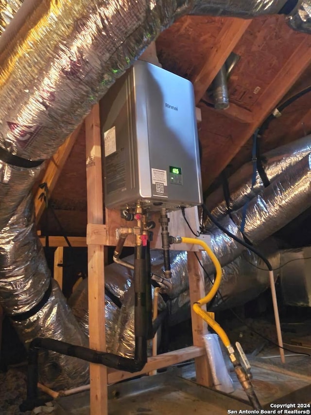 unfinished attic with water heater