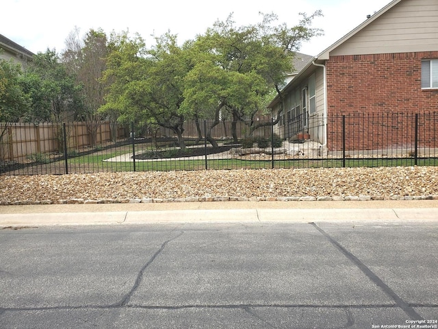 view of home's exterior with fence private yard and brick siding