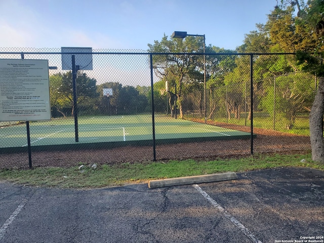 view of tennis court featuring fence