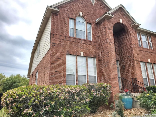 view of property exterior featuring brick siding