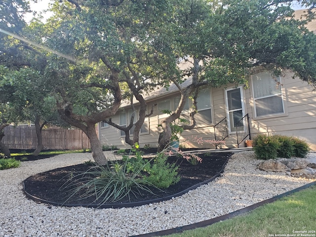 view of side of property with entry steps and fence