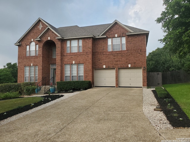 view of front facade with an attached garage, brick siding, a shingled roof, fence, and driveway