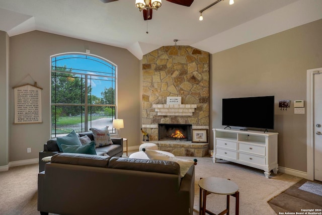 living room with a fireplace, ceiling fan, vaulted ceiling, and light colored carpet