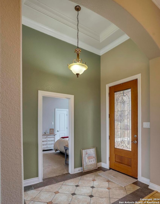 foyer featuring a raised ceiling and light tile floors