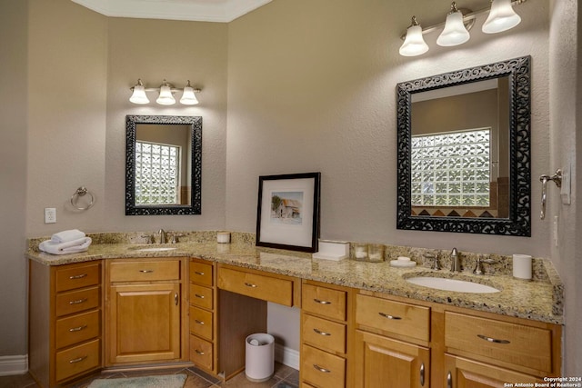 bathroom with crown molding, double vanity, and tile floors