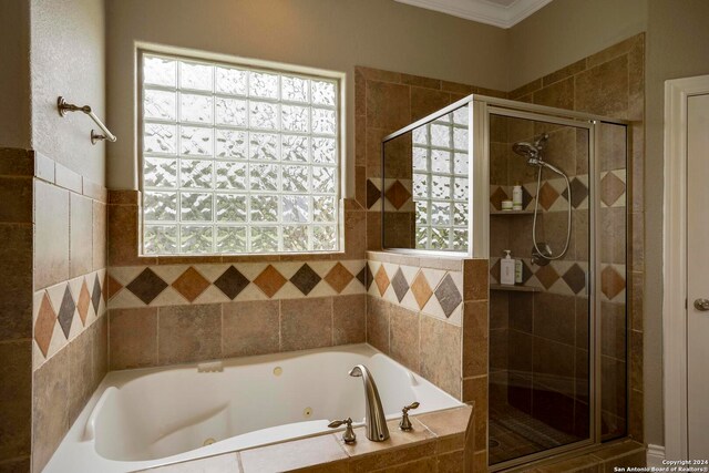 bathroom with plenty of natural light, ornamental molding, and plus walk in shower