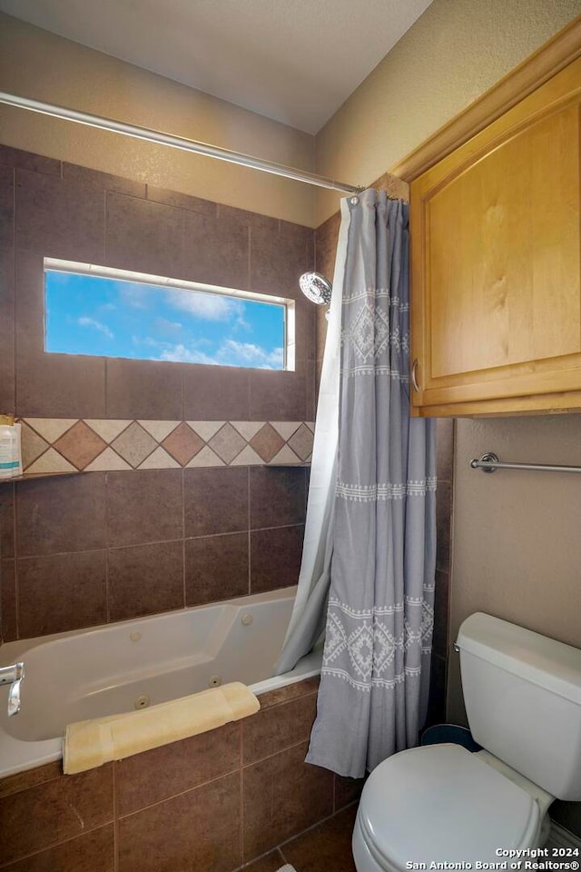 bathroom featuring toilet and shower / bath combination with curtain