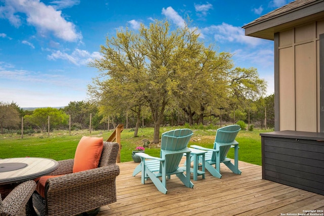 wooden deck featuring a lawn