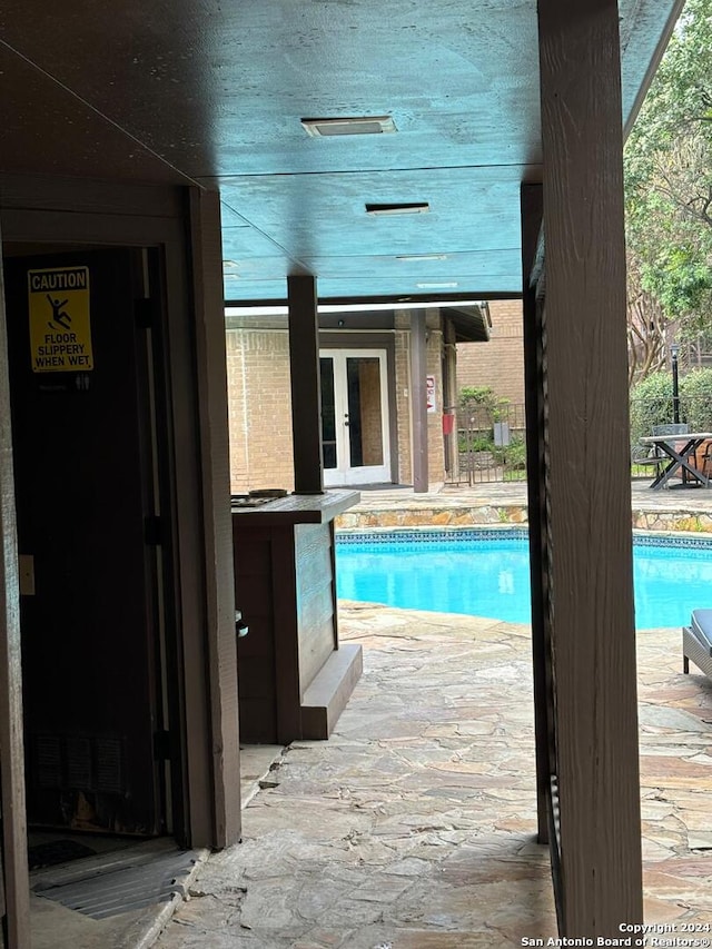 view of pool featuring french doors and a patio