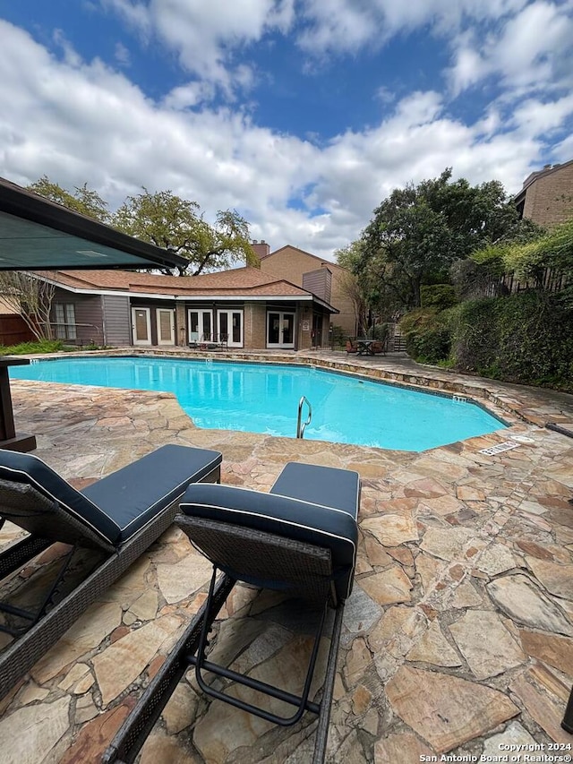 view of swimming pool featuring a patio area