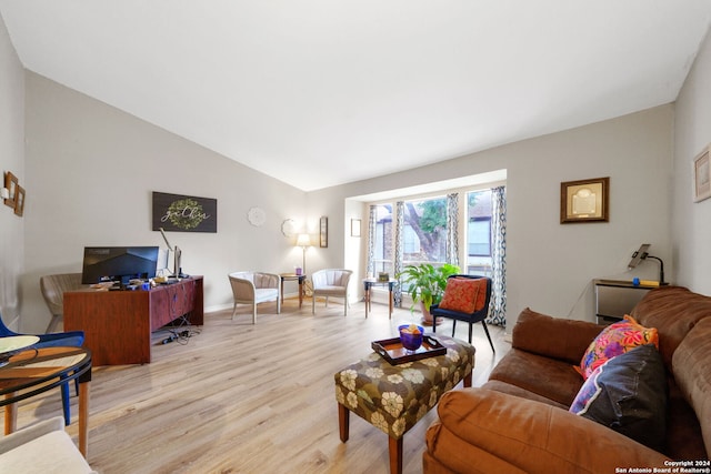 living room featuring light hardwood / wood-style flooring and high vaulted ceiling