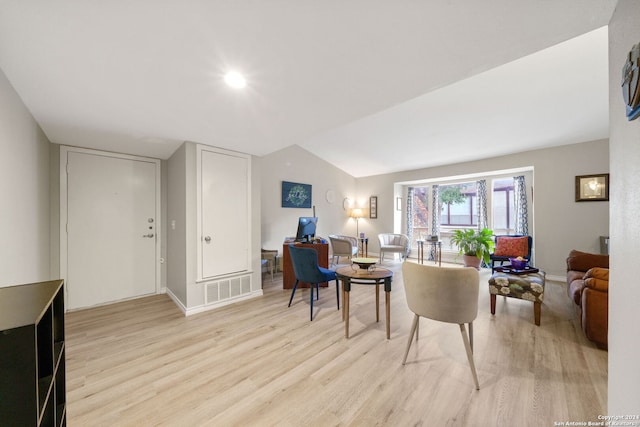 living room with lofted ceiling and light hardwood / wood-style flooring