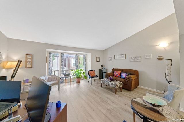 living room with light hardwood / wood-style floors and vaulted ceiling