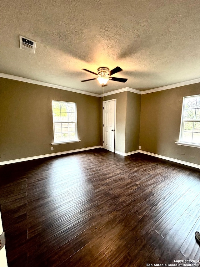 unfurnished room with crown molding, a textured ceiling, ceiling fan, and dark wood-type flooring