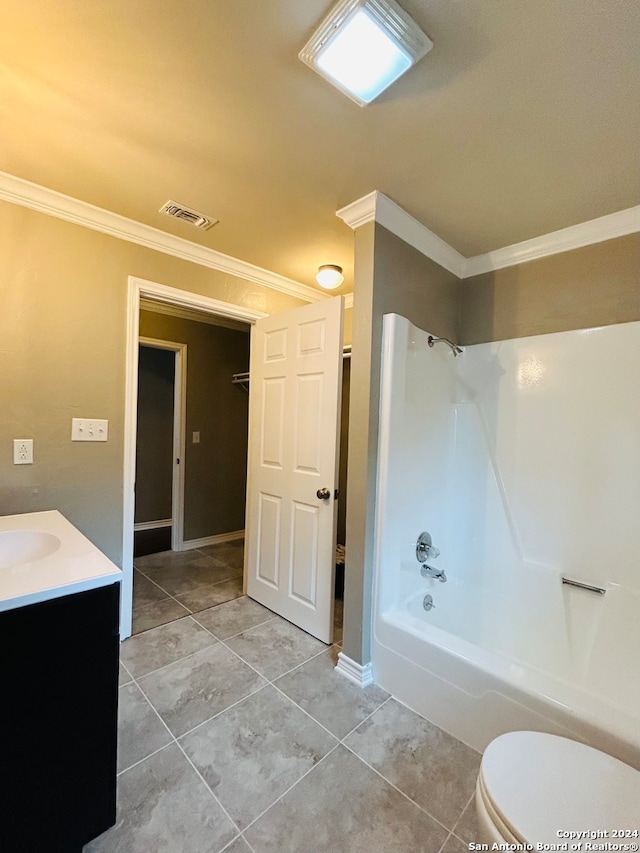 full bathroom with washtub / shower combination, tile flooring, toilet, vanity, and ornamental molding