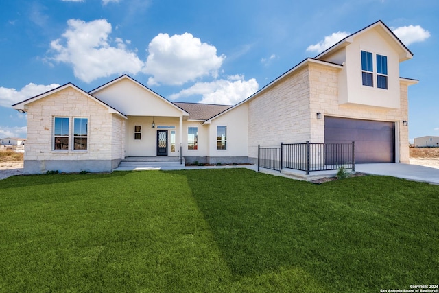 view of front facade featuring a front yard and a garage