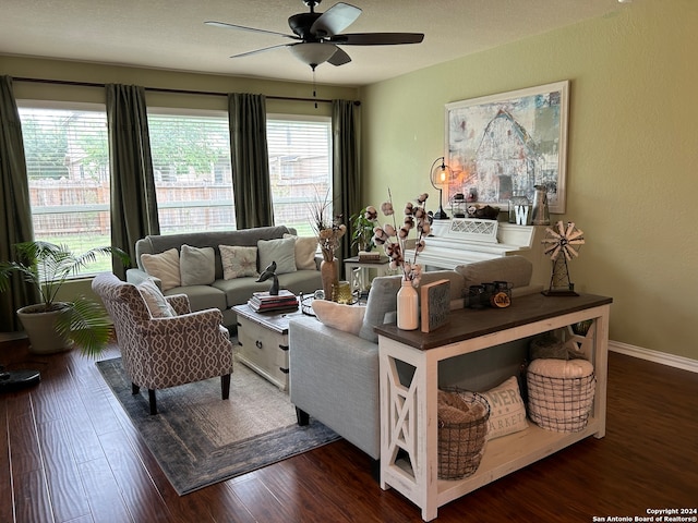 living room featuring ceiling fan and dark wood-type flooring