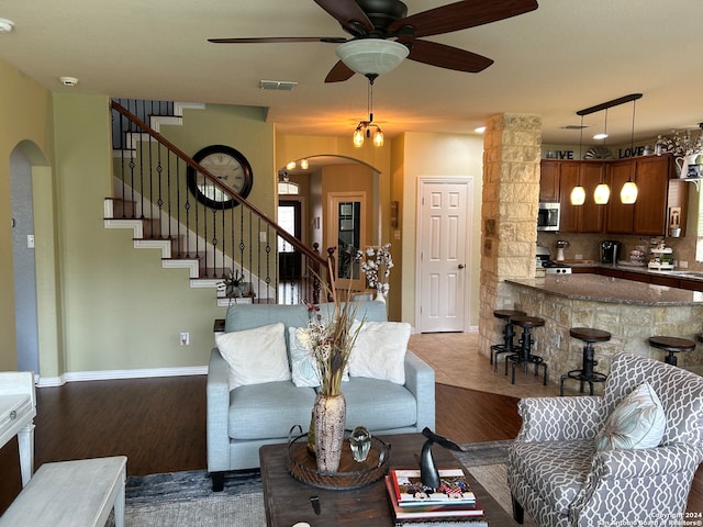 living room with light hardwood / wood-style flooring, ceiling fan, and rail lighting