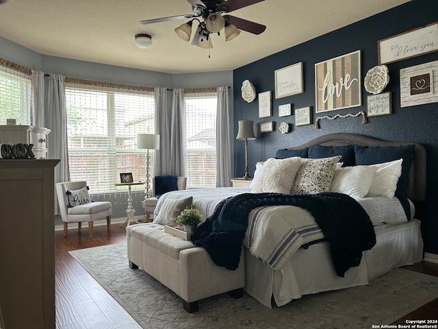 bedroom featuring ceiling fan and hardwood / wood-style flooring