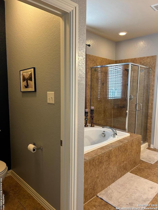 bathroom with toilet, tile flooring, and independent shower and bath