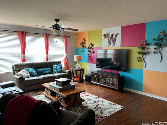 living room with plenty of natural light, dark hardwood / wood-style flooring, a textured ceiling, and ceiling fan