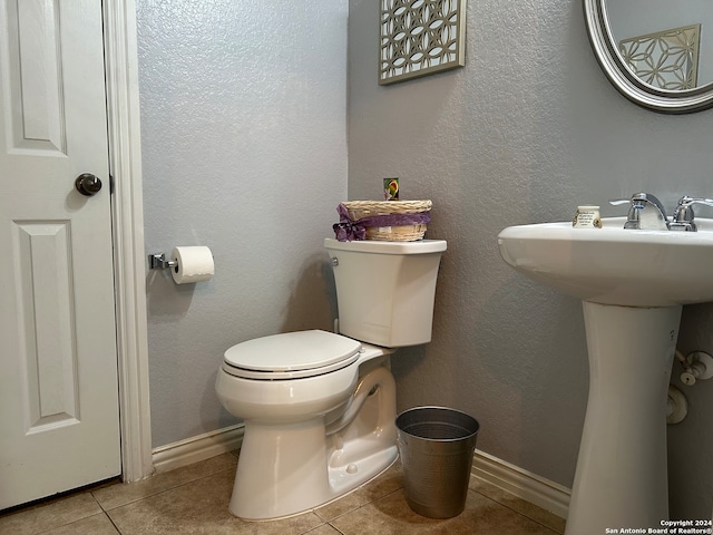 bathroom featuring tile floors and toilet