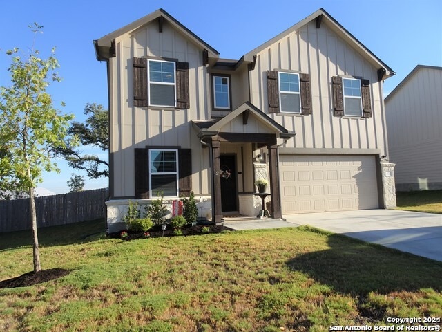 view of front of house featuring a front yard and a garage