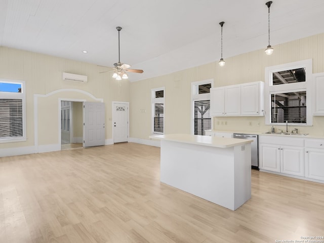 kitchen featuring light hardwood / wood-style floors, decorative light fixtures, ceiling fan, white cabinetry, and dishwasher