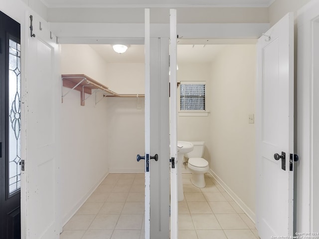 bathroom featuring toilet and tile floors