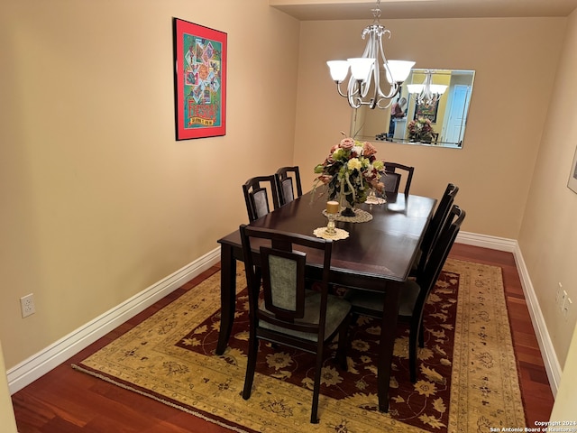 dining room featuring a notable chandelier and dark hardwood / wood-style floors